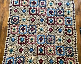 Granny squares afghan comforter blanket sofa throw. Muted multi color squares with beige borders.