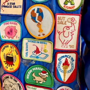 Puede incluir: Una colecci&oacute;n de parches bordados coloridos con varios dise&ntilde;os y texto. Los parches incluyen un saludo estrellado, un cerdo para una recaudaci&oacute;n de fondos, una tortuga con una bandana roja y un gallo. Los parches est&aacute;n sobre un fondo azul.
