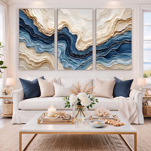 May include: A triptych wall art set featuring three vertical panels with textured, layered abstract waves in shades of deep navy blue, cream, and beige. The raised, sculpted paint creates a three-dimensional effect across the canvases.