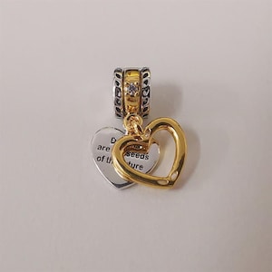 May include: A set of three ceramic mugs with a speckled, matte finish. The mugs are in shades of cream, light gray, and dark gray. Each mug has a simple, minimalist design and a rounded handle.