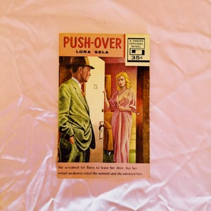 May include: A white ceramic mug with a black handle and the text "But First, Coffee" in a black, handwritten-style font. The mug is on a white surface.