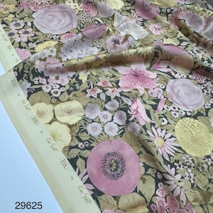 May include: Floral fabric with a repeating pattern of pink, yellow, and white flowers on a dark background. The fabric has a cream-colored selvage with text that reads "ISA by Ken Scott". The fabric width is 1.4 meters.