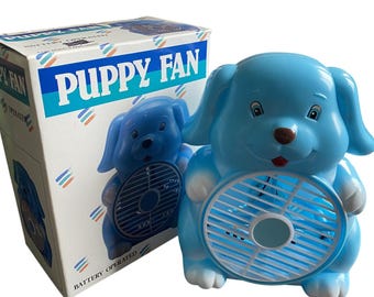 Abanico vintage de plástico azul con forma de cachorro, años 60, funciona con pilas, nuevo