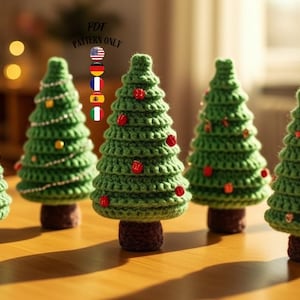 May include: A white ceramic mug with a black handle and the text "But First, Coffee" in a bold, black font. The mug is set against a blurred background, suggesting a cozy setting.