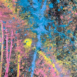 May include: Abstract artwork with a black background splattered with vibrant paint. The colors include bright blue, pink, and yellow, creating a dynamic and energetic composition. The paint is applied in drips and splatters.