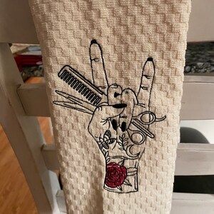 Dish towel  with hairdressers had on a ivory waffle terry  dish towel.