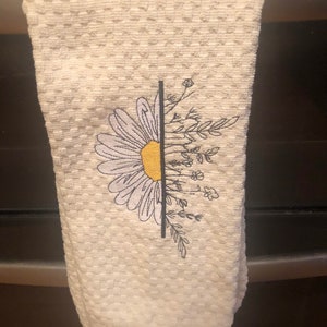 Dish towel with beautiful sunflower on ivory waffle weave towel.