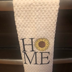 Dish with HOME and a sunflower on a ivory waffle terry  dish towel.