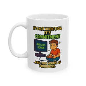 May include: White ceramic mug with a cartoon illustration of a boy playing a video game. The mug has the text "IT'S NOT ADDICTION, IT'S COMMITMENT AND 300 HOURS OF PROGRESS."