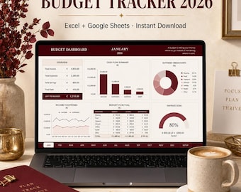 May include: A laptop displaying a budget tracker for 2026, with charts and graphs showing income, expenses, and savings. The screen shows the text "Budget Tracker 2026" and "Excel + Google Sheets". A notebook, coffee cup, and decorative items surround the laptop.