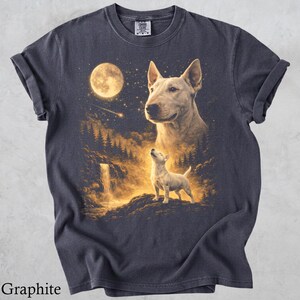 May include: A graphite-coloured short-sleeve t-shirt featuring a graphic print of a large Bull Terrier head above a smaller standing Bull Terrier in a forest landscape with a waterfall, a bright full moon, and a shooting star in the night sky.