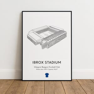 May include: A framed print featuring a detailed line drawing of Ibrox Stadium, home of the Glasgow Rangers Football Club. The stadium illustration is in black and white, with the stadium name and team details below. A blue jersey icon is at the bottom.