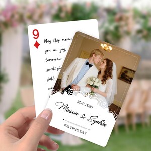 May include: A wedding-themed playing card featuring a photo of a couple, with the text "Mason & Sophia" and "Wedding Day." The card also includes the date "12.27.2025" and a decorative border.