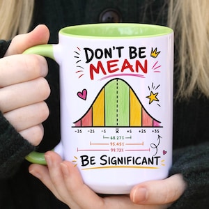 May include: A white ceramic mug with a light green interior and handle. The exterior features a colorful bell curve graph with the text "DON'T BE MEAN" at the top and "BE SIGNIFICANT" at the bottom, along with statistical percentage markers.