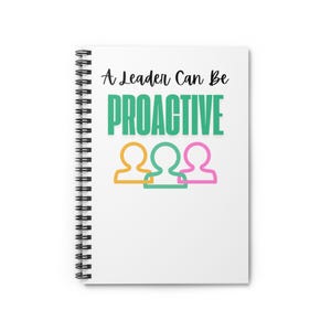 May include: White spiral-bound notebook with the text "A Leader Can Be PROACTIVE" in black and teal. Below the text are three stylized human figures in orange, teal, and pink. The notebook is blank.