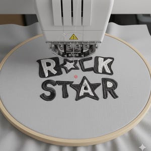 May include: An embroidery machine stitching the words "ROCK STAR" onto a light gray fabric stretched within a wooden hoop. The letters are black with white outlines, and a star replaces the letter "A".