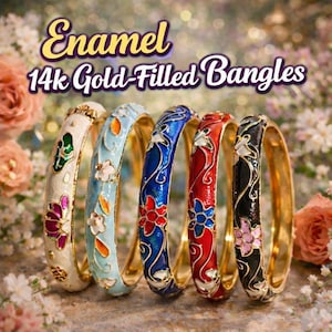 May include: Five enamel 14k gold-filled bangles in a row, each with a different color and floral design. Colors include white, light blue, dark blue, red, and black. The bangles have gold-colored rims and are set against a blurred floral background.