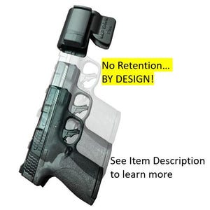 May include: A black handgun with a silver slide is shown with a black holster clip. The text "No Retention... BY DESIGN!" is in a yellow box. The text "See Item Description to learn more" is also visible.