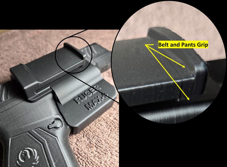 May include: Black polymer holster for a Ruger Max-9 pistol. The holster features a belt and pants grip design for secure carry. The Ruger Max-9 model name is visible on the side of the holster. The holster is designed for concealed carry.