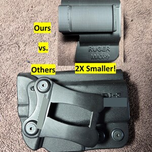 May include: Black holster with the text "RUGER MAX-9" and a comparison to another holster. The image includes the text "Ours vs. Others 2X Smaller!"