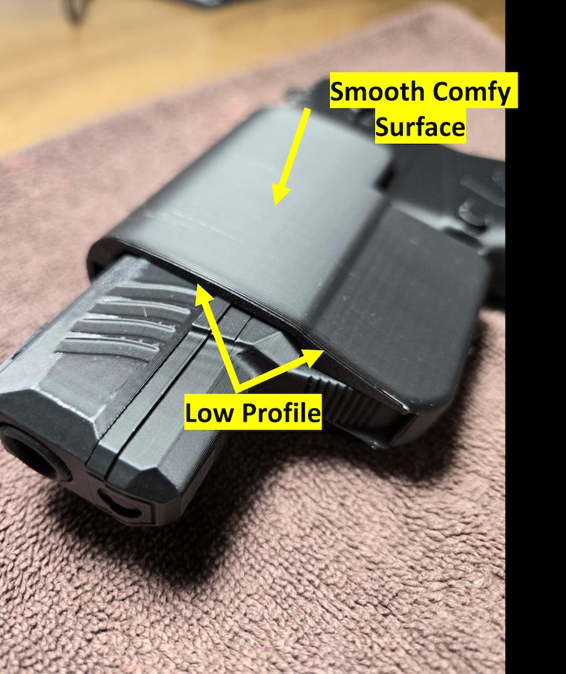 May include: A black, low-profile object with a smooth, comfy surface. The object is resting on a brown, textured surface. The text "Smooth Comfy Surface" and "Low Profile" are visible.
