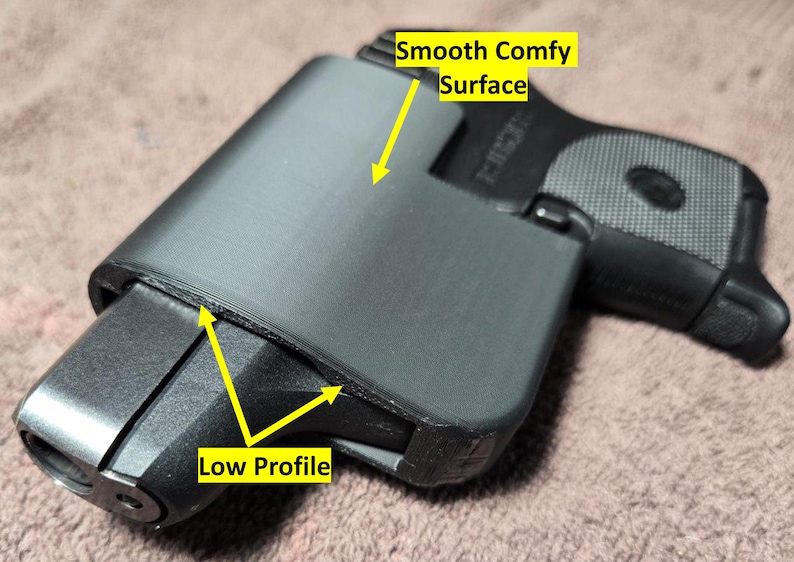 May include: Black holster with a smooth, comfortable surface and low profile design. The holster is designed to fit a handgun. The image shows the holster's features, including its shape and texture.