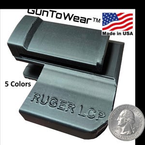 May include: Black Ruger LCP magazine holder with the text "RUGER LCP" and "Gun To Wear" printed on it. The holder is made in the USA and available in 5 colors. A US quarter is shown for size comparison.