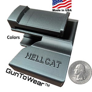 May include: Black accessory with the word "HELLCAT" embossed on the surface. The text "Gun To Wear" is also visible. The image includes a quarter for size comparison, and the text "Made in USA".