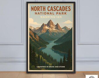 May include: A framed poster featuring a vintage-style illustration of North Cascades National Park in Washington. The artwork depicts a mountain range, a lake, and evergreen trees, with text that reads "North Cascades National Park Washington" and "Crowned in Snow and Stone."