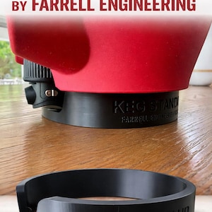 May include: A black keg stand with the text "KEG STAND" and "BY FARRELL ENGINEERING" in white. A red keg is partially visible on top. The stand is on a wooden surface.