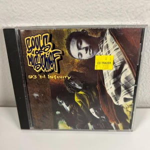 May include: A CD case featuring the album "93 'til Infinity" by Souls of Mischief. The cover art displays the band members and album title in a stylized font. A yellow sticker from "CD Trader" is visible.