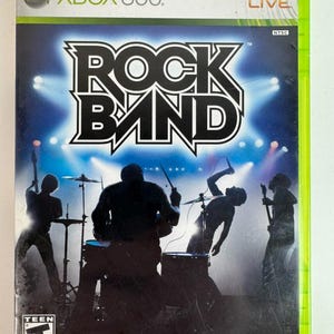 May include: The Rock Band video game for Xbox 360 features a green plastic case with a cover showing silhouettes of a band performing on stage under bright lights. The title Rock Band is printed in large white letters with a black outline.