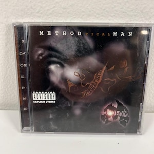 May include: A compact disc case featuring the album cover for "Methodical Man." The cover art is dark with a close-up of a person's face and abstract designs. The Parental Advisory Explicit Lyrics label is visible.
