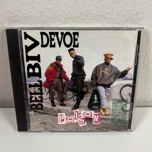 May include: A CD case featuring the group Bell Biv DeVoe. The album cover displays three men in casual attire, with the word "DEVOE" above them. The album title "Poison" is at the bottom, with text on the right side.