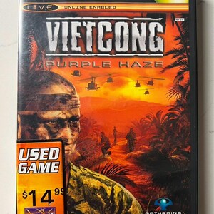 May include: Xbox game case for "Vietcong: Purple Haze." The cover art features a soldier, helicopters, and soldiers in a jungle setting with a fiery orange sky. The case has a "Used Game" sticker.