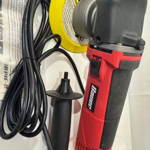 May include: A red and black Bauer electric polisher with a 6-inch yellow foam pad, a detachable black side handle, and a long black power cord. The tool features a power switch on the handle and includes an owner's manual with visible text.