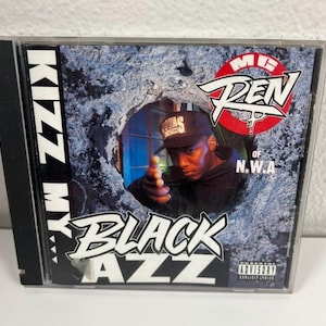 May include: A CD case featuring the album "Black Azz" by Kizz My Ass. The cover art includes a portrait of a man wearing a cap, pointing a finger. The album title is in a stylized font, with the text "MC Ren of N.W.A."