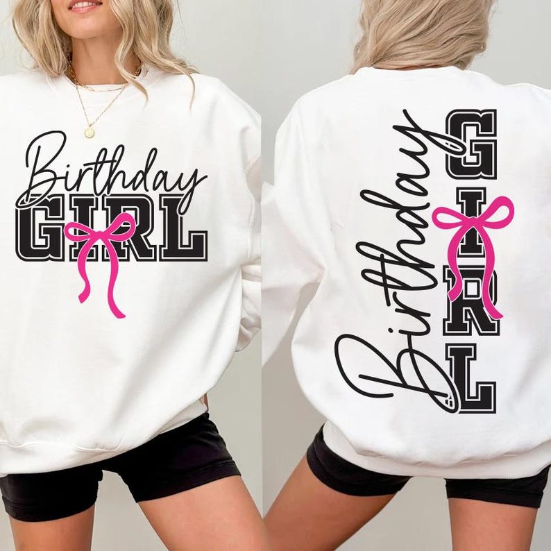 May include: White sweatshirt with the text "Birthday GIRL" in black script and block letters, accented with a pink bow. The design is on the front and back of the sweatshirt. The sweatshirt is worn by a person.