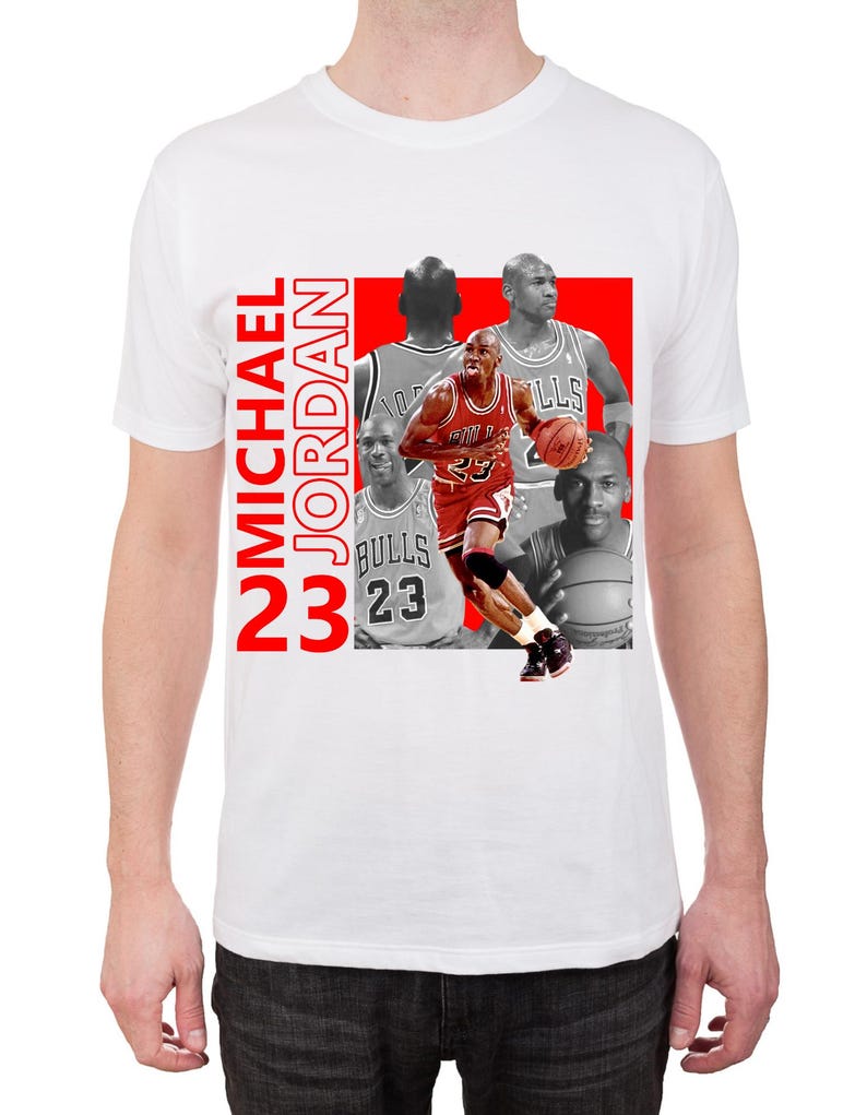 May include: White t-shirt featuring a graphic of Michael Jordan in action, with the number 23 and the name "MICHAEL JORDAN" in red. The design includes multiple images of Jordan.