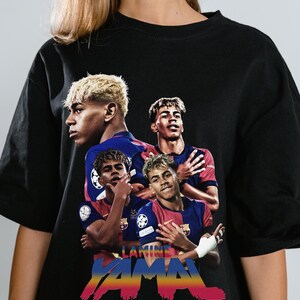 May include: Black t-shirt with a graphic of a soccer player in a blue and red kit. The design includes multiple images of the player. The name "LAMINE YAMAL" is written in colourful, stylised text across the bottom of the shirt.