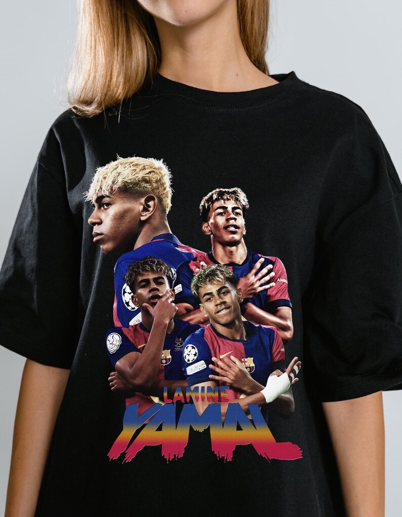 May include: Black t-shirt with a graphic of a soccer player in a blue and red kit. The design includes multiple images of the player. The name "LAMINE YAMAL" is written in colourful, stylised text across the bottom of the shirt.