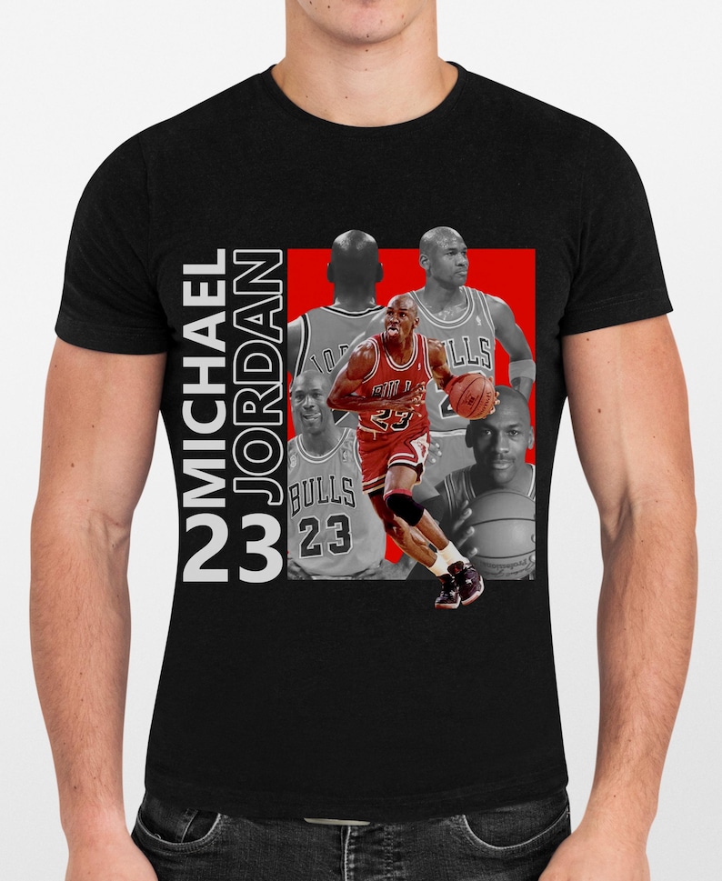 May include: Black t-shirt featuring a collage of Michael Jordan in action. The design includes images of Jordan in his Bulls uniform, with the text "MICHAEL JORDAN 23" in white. The background is a red rectangle.