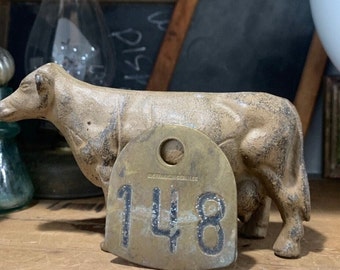 Vintage Cow Tag / Number 148 / #148 /  Industrial brass number / O.M. Franklin Serum Co. / Vintage decor / vintage display /