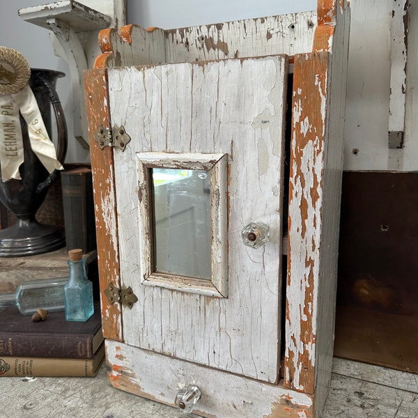 Vintage hanging cabinet /  Old , chippy white paint / Orange accents /  mirrored door / old cabinet with drawer /  wood shelf / Glass knobs