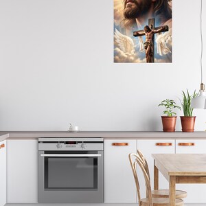 May include: A wall art print featuring a large, detailed portrait of Jesus Christ with a crown of thorns, positioned above a smaller depiction of Jesus on the cross, surrounded by white angel wings and soft, golden clouds in a bright sky.