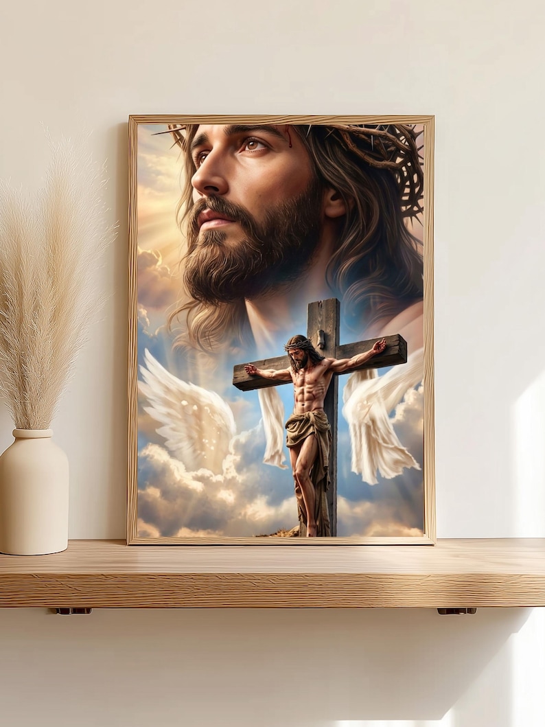 May include: A framed wall art print featuring a large, ethereal portrait of Jesus wearing a crown of thorns, positioned above a smaller depiction of Jesus on a wooden cross. The scene is set against a backdrop of soft clouds and white wings.