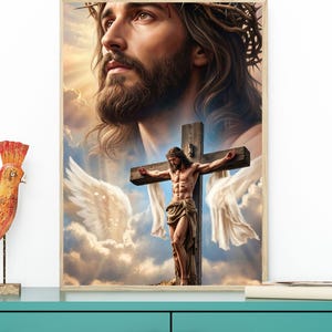 May include: A framed wall art print featuring a large, detailed portrait of Jesus wearing a crown of thorns, positioned above a smaller depiction of Jesus on a wooden cross with white fabric draped over the arms, set against a cloudy sky.