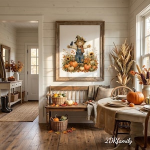 Puede incluir: Una lámina de arte enmarcada con una ilustración en acuarela de un espantapájaros con peto azul rodeado de calabazas, girasoles y un pequeño pájaro negro. La obra está expuesta en una habitación rústica con un banco de madera.