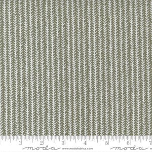 May include: A fabric with a repeating pattern of white, stylized leaf shapes on a muted olive green background. The design is arranged in vertical rows, creating a textured appearance. The fabric is suitable for quilting and sewing projects.