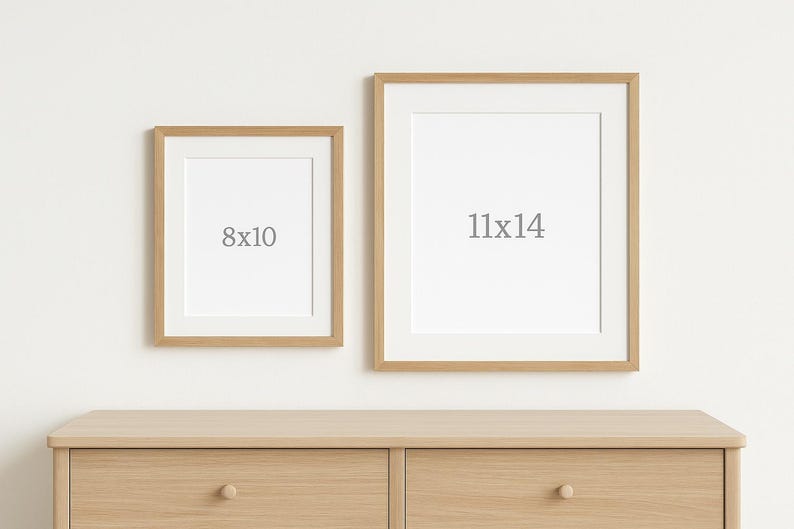 Op de afbeelding: Twee ingelijste kunstdrukken, &eacute;&eacute;n van 20x25 cm en de andere van 28x35 cm, worden gepresenteerd op een lichte houten dressoir. De lijsten zijn licht van kleur en de prints hebben een witte passe-partout. De tekst "8x10" en "11x14" staat op de kunst.